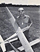 Kneeling with his planes